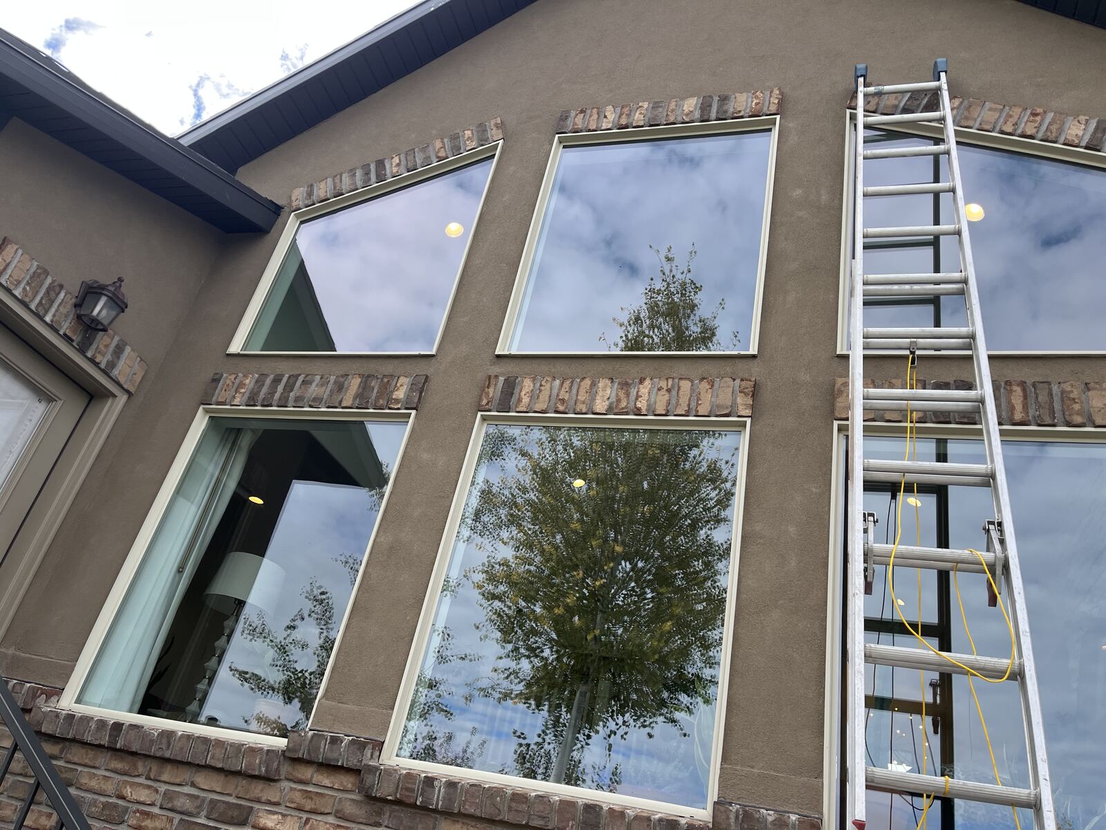 A two-storey wall of clean windows with Wes's extension ladder against it